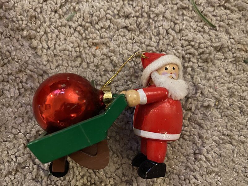 A wood Santa with a wheelbarrow